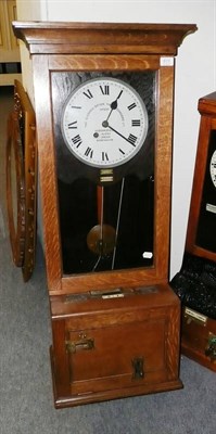 Lot 613 - An oak cased time recording clock