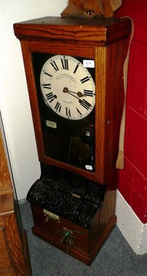 Lot 614 - An oak cased time recording clock