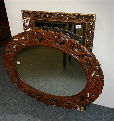 Lot 616 - A carved oak mirror and another