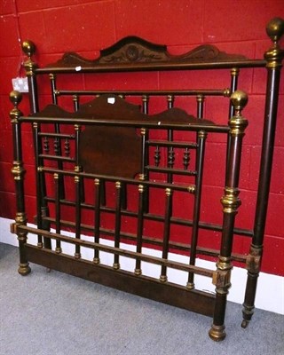 Lot 619 - A pair of carved wooden and brass bed ends