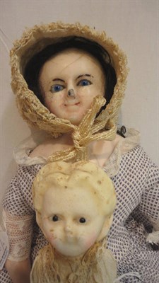 Lot 1030 - Circa 1860 Wax Over Shoulder Doll with blue fixed glass eyes, black wig on a cloth body, wax...