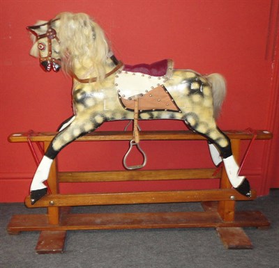 Lot 1045 - A Dapple Grey Rocking Horse on a swing stand, with a leather bridle, leatherette saddle and...