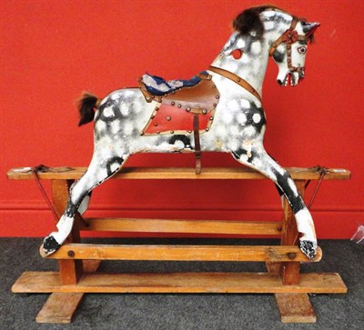 Lot 1049 - A Dapple Grey Rocking Horse on a swing stand, with a leather bridle, leatherette saddle and...