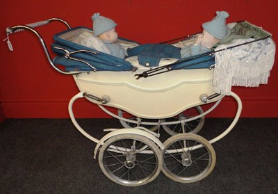 Lot 1050 - A Marmet Double Baby Pram on a cream painted body, with a blue double canvas hood and cover, cotton