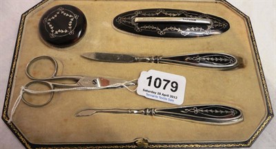 Lot 1079 - A Walker and Hall Tortoiseshell Pique Decorated Manicure Set in fitted case (later scissors)