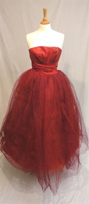 Lot 1125 - Circa 1960's Frank Usher Red Strapless Evening Gown, with net mounted bodice and skirt, satin waist