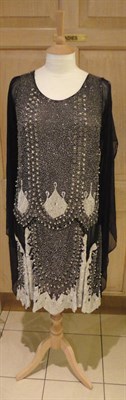 Lot 1180 - Circa 1920's Black Chiffon Shift Dress with stylised silver and white beaded detailing and...