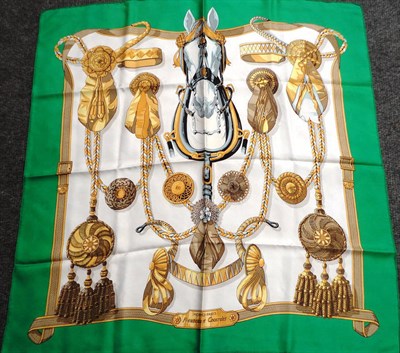 Lot 1205 - Hermès Silk Scarf  Frontaux et Cocardes with a grey horses head to the centre within a green...