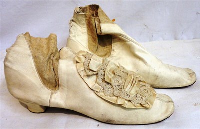 Lot 1227 - Pair of 19th Century White Kid Leather Heeled Boots, one still has a cream silk and lace rosette to