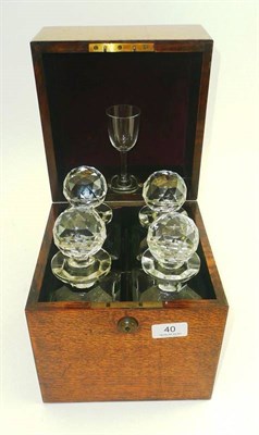 Lot 40 - An oak cased four division decanter cellerette