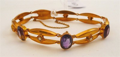 Lot 105 - An amethyst and seed pearl bracelet stamped '9CT'
