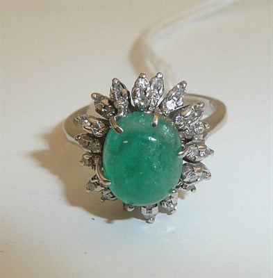 Lot 110 - An emerald and diamond cluster ring, an oval cabochon emerald in a white six claw setting, within a