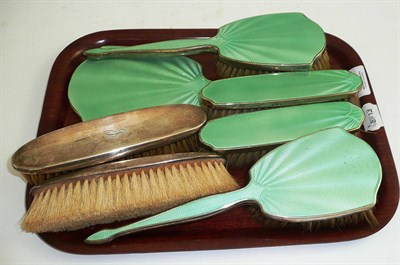 Lot 264 - A silver and green guilloche enamel backed vanity set and two silver backed clothes brushes