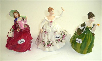 Lot 295 - Three Royal Doulton figures: Autumn Breezes, Shirley and Fleur