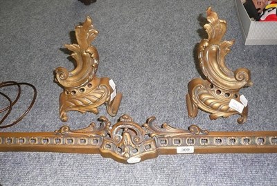 Lot 309 - A pair of brass chenet and a small fender