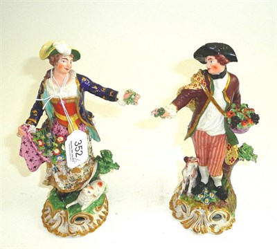 Lot 352 - A pair of early 19th century Derby figures, one with basket of fruit and a dog, the other with...