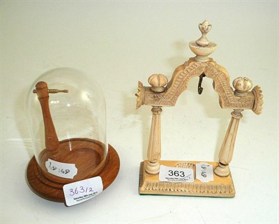 Lot 363 - Indian ivory pocket watch stand and an oak pocket watch stand under a dome