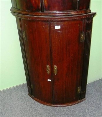 Lot 480 - An oak and mahogany bow front corner cupboard