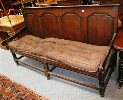 Lot 504 - An 18th century oak panel back settle