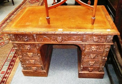 Lot 505 - Small carved oak knee hole desk