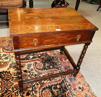 Lot 511 - An oak single draw side table on bobbin turned legs (a.f.)