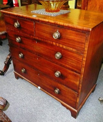 Lot 517 - A 19th century mahogany straight front chest of two short and three long graduated drawers with...