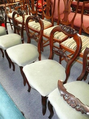 Lot 528 - A set of six Victorian mahogany balloon back dining chairs with carved backs