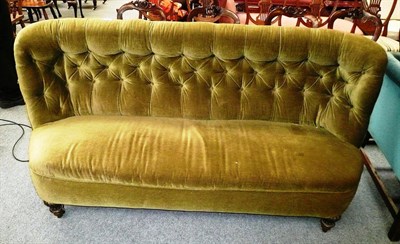 Lot 530 - Green upholstered mahogany sofa with feet on castors