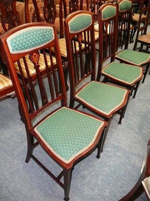 Lot 542 - A set of four Edwardian mahogany side chairs with inlaid splats