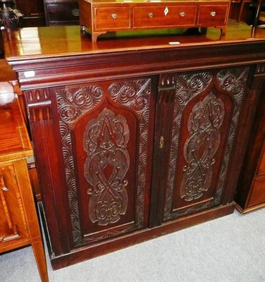 Lot 565 - A carved mahogany double door cabinet with fitted interior of filling drawers