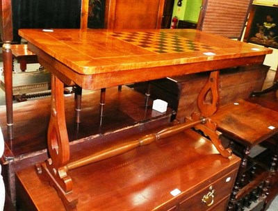 Lot 570 - A walnut chess top coffee table