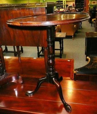 Lot 575 - A mahogany flip-top pedestal table with circular dished top