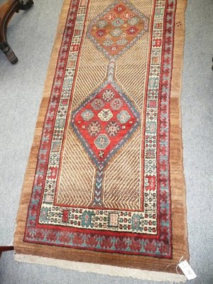 Lot 592 - A narrow Sarab runner, Persian Azerbaijan, the panelled field with a single row of polychrome...