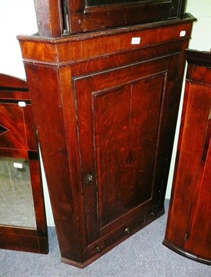 Lot 604 - An oak corner cupboard