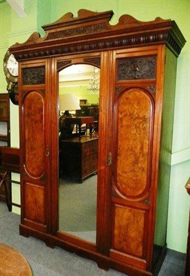 Lot 611 - A Victorian walnut triple wardrobe