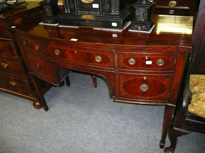 Lot 621 - A George III style mahogany bowfront sideboard on square tapering legs