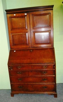 Lot 629 - An early 19th century oak bureau bookcase