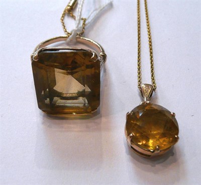 Lot 61 - A citrine ring with leaf design shoulders, a citrine pendant on chain