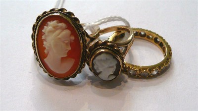 Lot 84 - An eternity ring stamped '18CT', a 9ct gold cameo ring, and a cameo ring stamped '9CT' (3)