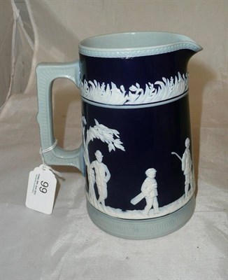 Lot 99 - A Copeland Pottery Golfing jug, relief moulded with a golfing scene on a dark blue ground,...