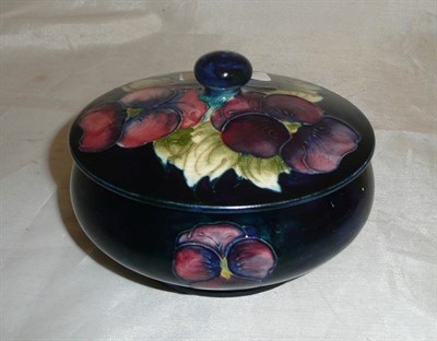 Lot 101 - A Walter Moorcroft "Pansy" pattern powder bowl and cover, on a blue ground, impressed factory marks