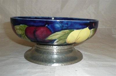 Lot 105 - A William Moorcroft "Wisteria" pattern pedestal bowl, on a blue ground, impressed factory marks and