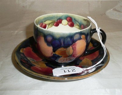 Lot 211 - A Moorcroft cup and saucer