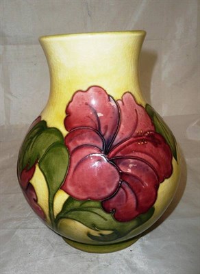 Lot 237 - A Walter Moorcroft 'Hibiscus' vase, on a yellow/green ground, impressed factory mark and...