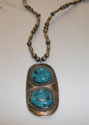 Lot 302 - An American-Indian Necklace, white metal bead and barrel links suspend a large pendant of...