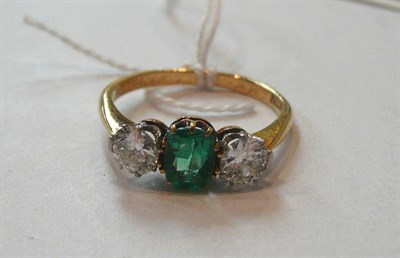 Lot 308 - An emerald and diamond three stone ring