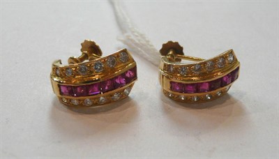 Lot 312 - A Pair of Ruby and Diamond Cuff Earrings, a line of square cut rubies in a yellow rubbed over...