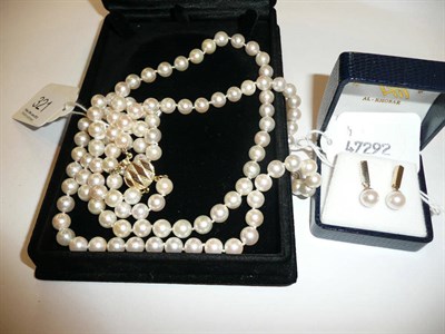 Lot 321 - A two strand cultured pearl necklace, boxed and matching drop earrings, boxed