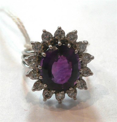 Lot 330 - An Amethyst and Diamond Cluster Ring, an oval mixed cut amethyst within a border of round brilliant