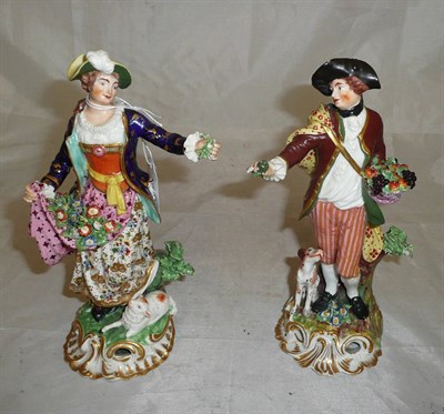 Lot 335 - A pair of early 19th century Bloor Derby figures, one with basket of fruit and a dog, the other...